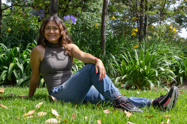 Beautiful young woman posing in a public park