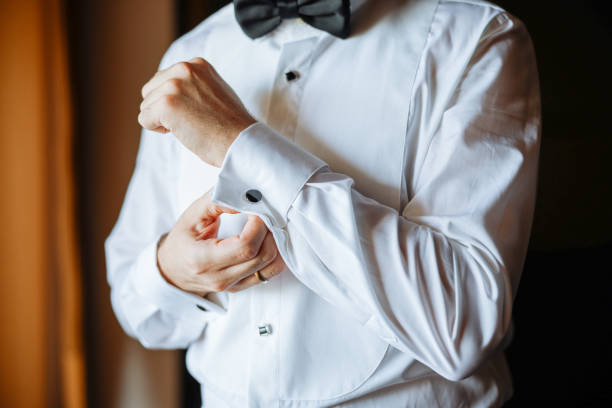A groom preparing to marry the love of his life. Close up of businessman wearing cufflinks. Elegant young fashion business man wearing suit