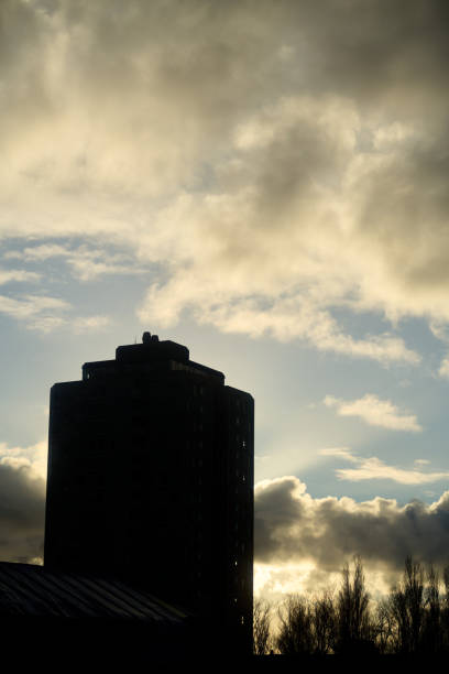 istock Imposing building silhouette against cloudy sky at sunset 2193575192