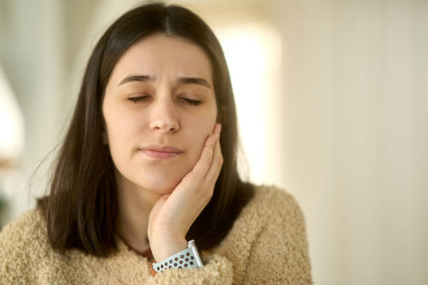 istock Young woman suffering from toothache, holding her cheek 2193575213