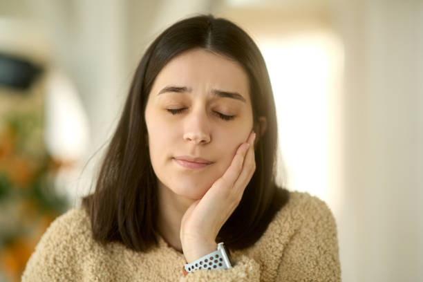 istock Young woman suffering from toothache touching her cheek 2193575217