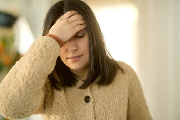 istock Young woman suffering from headache at home 2193575222