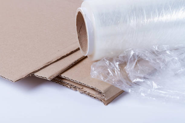 istock Packing the goods in a cardboard box and stretch film. Tools for packing parcels at the post office. 2193576233