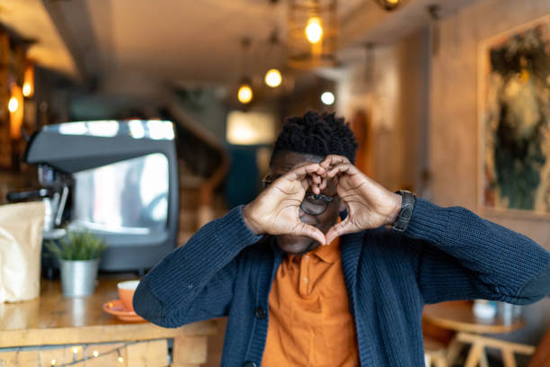 Happy black man making a heart sign with his hands