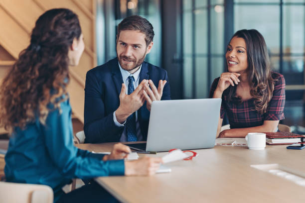 istock Businessman explaining a concept to his colleagues 2193579560