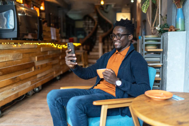 istock Man in cafe watching something on his smartphone. 2193579561