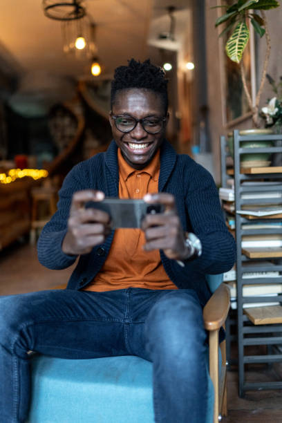 istock Man in cafe watching something on his smartphone. 2193579604