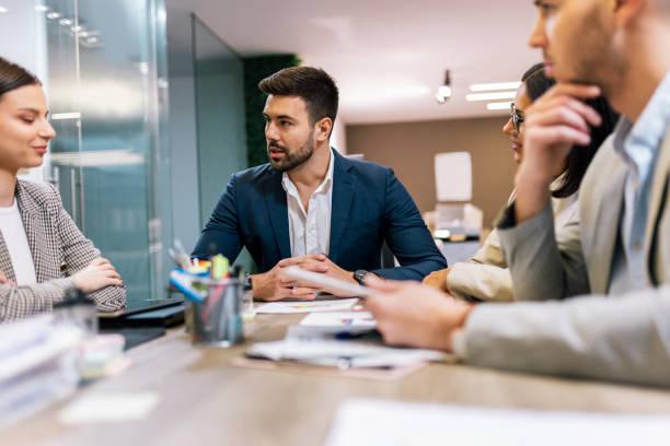 istock Workers group and team leader having teamwork discussion managing project at work in meeting room. 2193579614