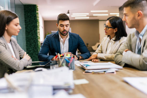 istock Workers group and team leader having teamwork discussion managing project at work in meeting room. 2193579698