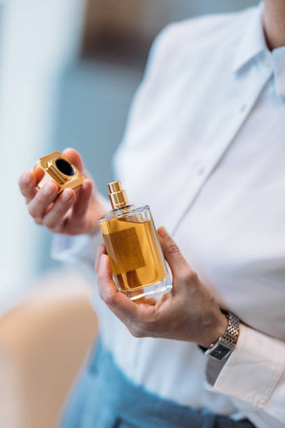 istock Woman Demonstrating a Perfume Bottle in an Elegant and Professional Setting 2193580212
