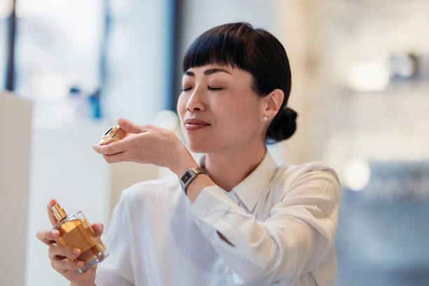 istock Woman Appreciating Perfume Aroma in Elegant Setting 2193580214