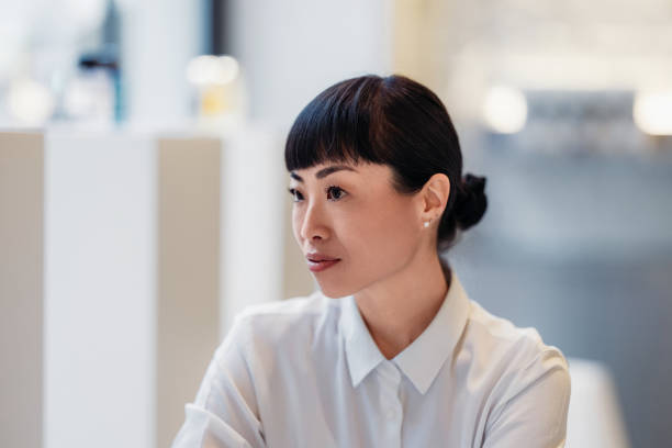 istock Elegant Woman in Professional Setup Looking Intently at a Discussion 2193580216