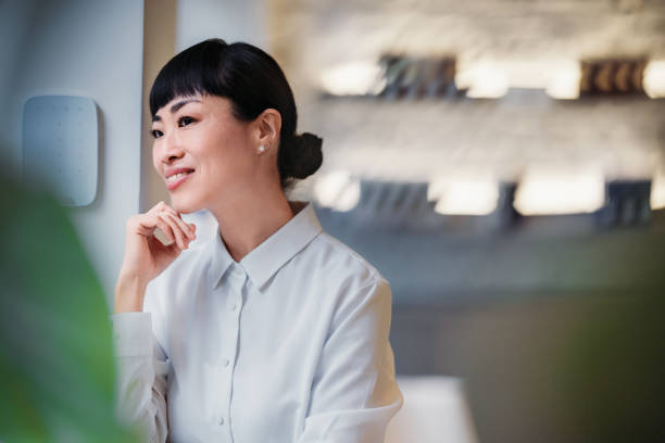 istock Smiling Professional Woman in Modern Office Setting with Elegant Interior Design 2193580219