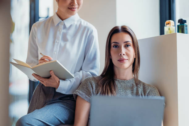 istock Two Women Collaborating in a Modern Office Setting on a Professional Project 2193580262