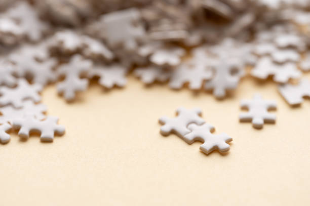 istock Scattered White Puzzle Pieces on Beige Background 2193580382
