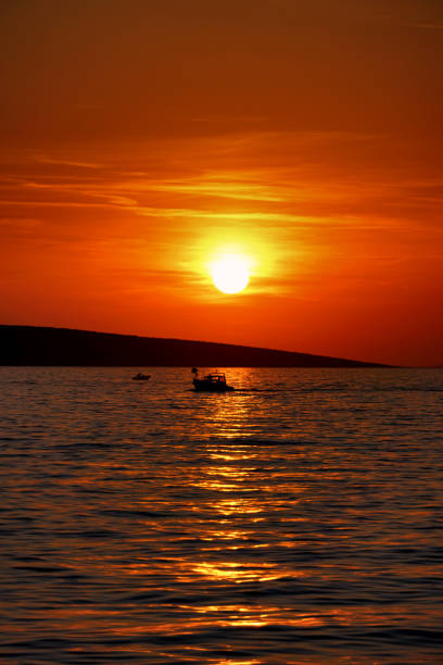 Beautiful sunrise on sea background with tropical wooden fishing boat pink tone