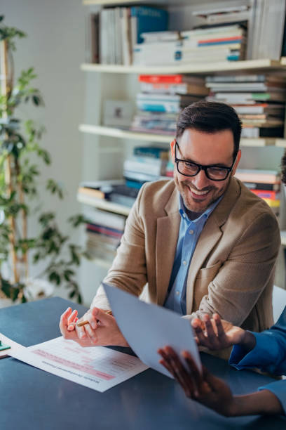 istock Smiling Team Members Collaborating in an Office Setting on Business Documents 2193581091