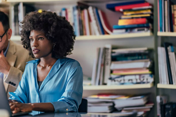 istock Professional Woman Working in an Office Space with Team Collaboration 2193581099