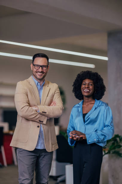 istock Confident Business Professionals Smiling in a Modern Office Environment 2193581149