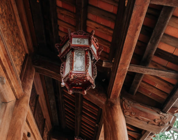 istock A Beautiful Traditional Lantern Elegantly Hanging from a Rustic Wooden Roof Structure 2193583039
