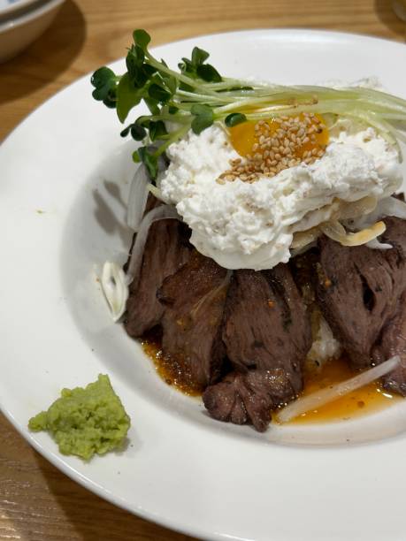 istock Bowl of rice served with Beef steak 2193583665