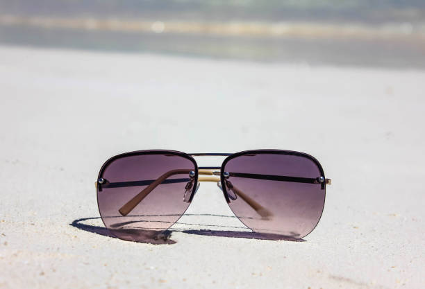 istock Summer concept, sunglasses in the sand on the beach 2193585092