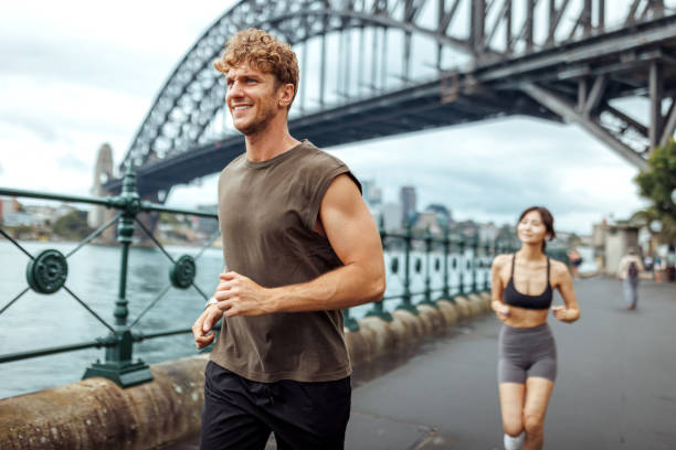 istock Young multiracial couple running together outdoors in Sydney 2193588369