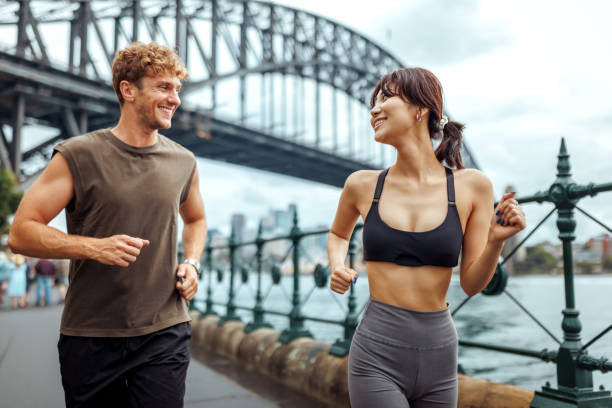 istock Young multiracial couple running together outdoors in Sydney 2193588370