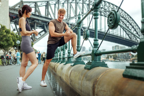 Young couple stretching before running outdoors
