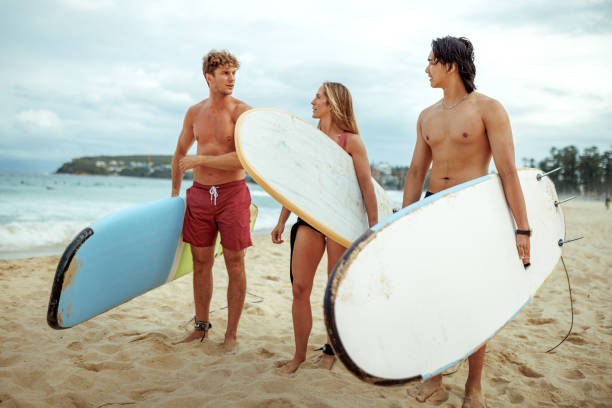 istock Three surfers enjoying their day on a beach together 2193589589