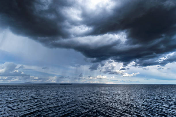istock Cloudy rainy weather. Beautiful dark dramatic sky and lake. 2193590302