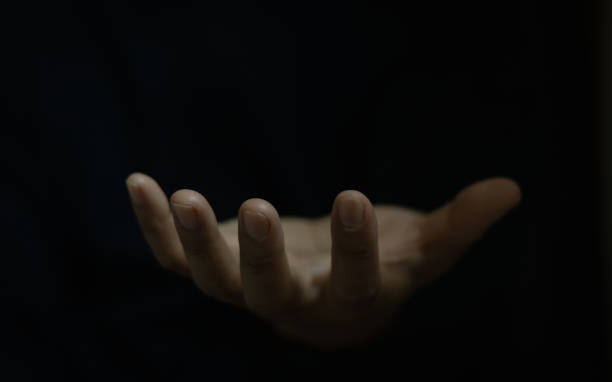 istock Open hand gesture, isolated on black background. Praying hands with faith in religion and belief in God on blessing background. Power of hope or love and devotion. Man hand hold hope help support. 2193590607