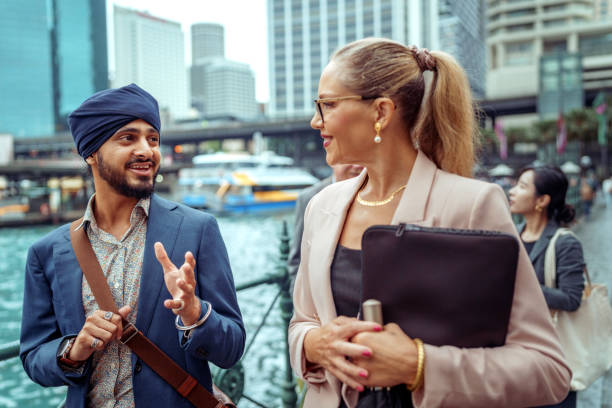 istock Two diverse colleagues walking and talking at the Sydney Harbour 2193590905