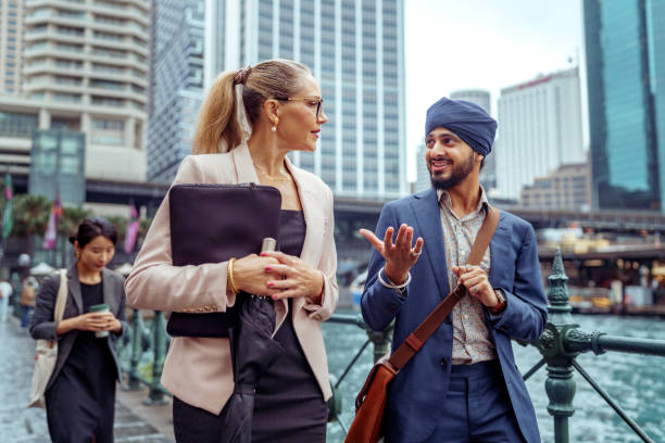 istock Two diverse colleagues walking and talking at the Sydney Harbour 2193590914