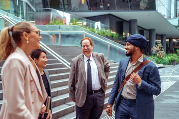 istock Four diverse business people talking outdoors at the city 2193590923