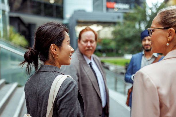 istock Four diverse business people talking outdoors at the city 2193590945