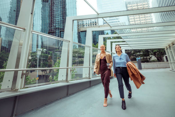 istock Two businesswomen walking outdoors together 2193591139