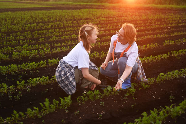 istock mother and daughter checking vegetable field progress 2193594834