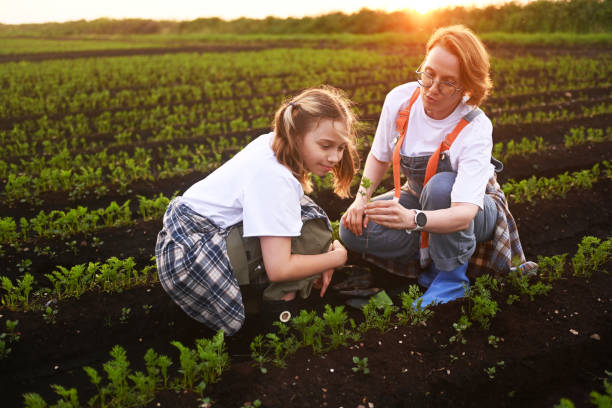 istock mother and daughter checking vegetable field progress 2193594965