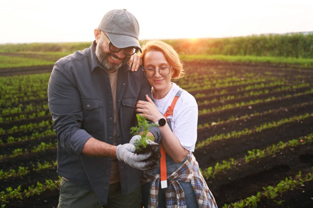 istock man and woman farmers checking vegetable field progress 2193597651