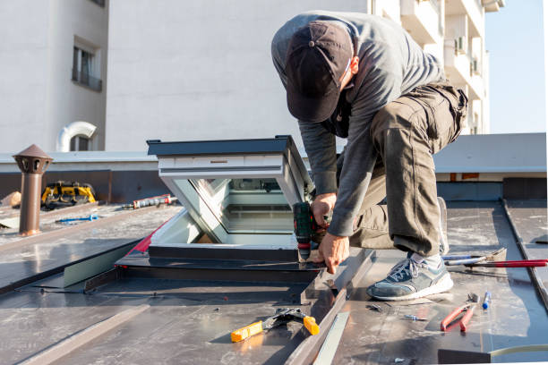 istock Tinsmith worker using cordless drill screws to install new metal sheet roof. 2193597665