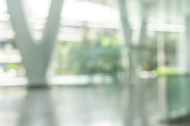 istock Blurred business office building lobby or hotel blur background interior view toward reception hall, modern luxury lounge, white room space with blurry corridor and glass wall 2193598252