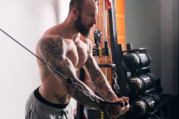 istock concentrated muscular man doing exercise at gym 2193598417