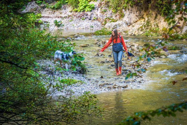 istock Young Caucasian Female and Dog Exploring Rocky River 2193598992