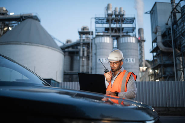 istock Engineer working with laptop and report a problem on walkie talkie. 2193599028