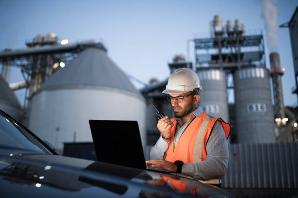 istock Engineer is reptorting a problem with a walkie talkie on the power station at a night shift. 2193599029