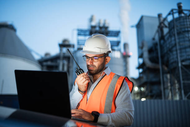 istock Engineer working with laptop and report a problem on walkie talkie. 2193599033