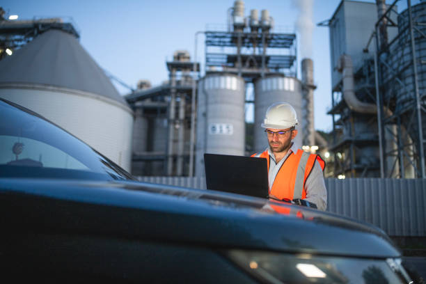 istock Engineer is reptorting a problem with a walkie talkie on the power station at a night shift. 2193599035