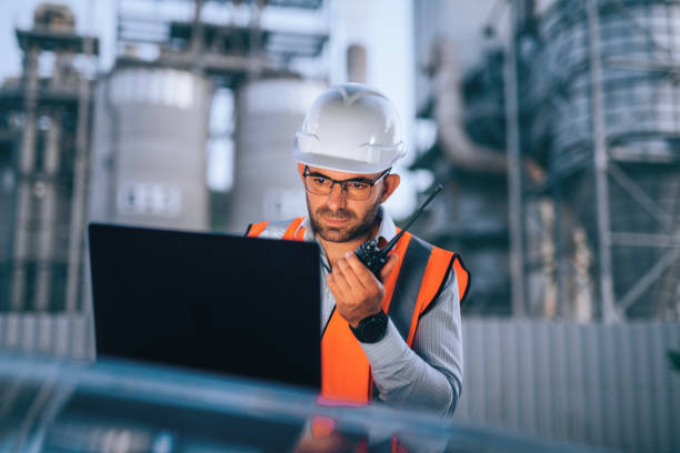 istock Engineer working with laptop and report a problem on walkie talkie. 2193599038