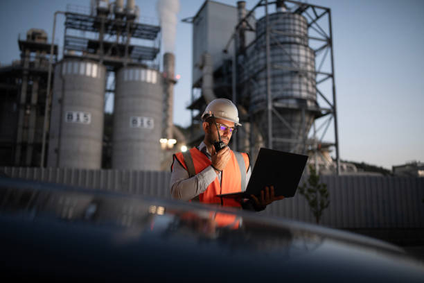 istock Engineer is reptorting a problem with a walkie talkie on the power station at a night shift. 2193599042